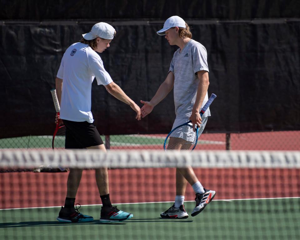 Salina Central's Collin and Connor Phelps react after scoring Saturday May. 14, 2022, at Kossover Tennis Court in Topeka.