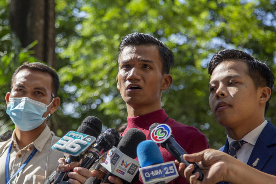 Pro-democracy activist Panupong Jadnok, also known as Mike Rayong, center, speaks as he arrives at criminal courthouse for hearing to determine whether he has violated his bail conditions in Bangkok, Thailand, Thursday, Sept. 3, 2020. Growing pro-democracy protests have emerged as the most serious threat to the government led by a former army general accused of incompetence and corruption by protesters. (AP Photo/Gemunu Amarasinghe)