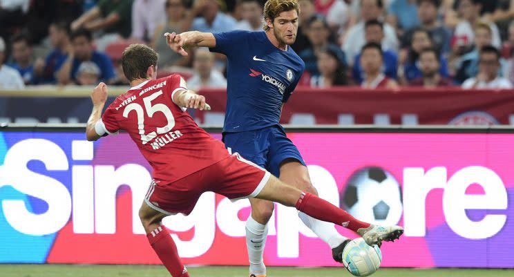 Marcos Alonso of Chelsea gets tackled by Thomas Muller of Bayern Munich during the International Champions Cup 2017 match between soccer clubs Bayern Munich from Germany and Chelsea of England, Tuesday, July 25, 2017 in Singapore. (AP Photo/Joseph Nair)