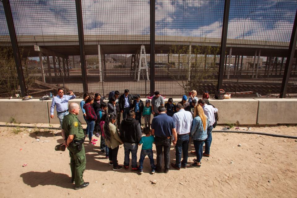 Evangelical pastors pray with migrants from Honduras, Guatemala and El Salvador in El Paso, Texas, on March 28, 2019.