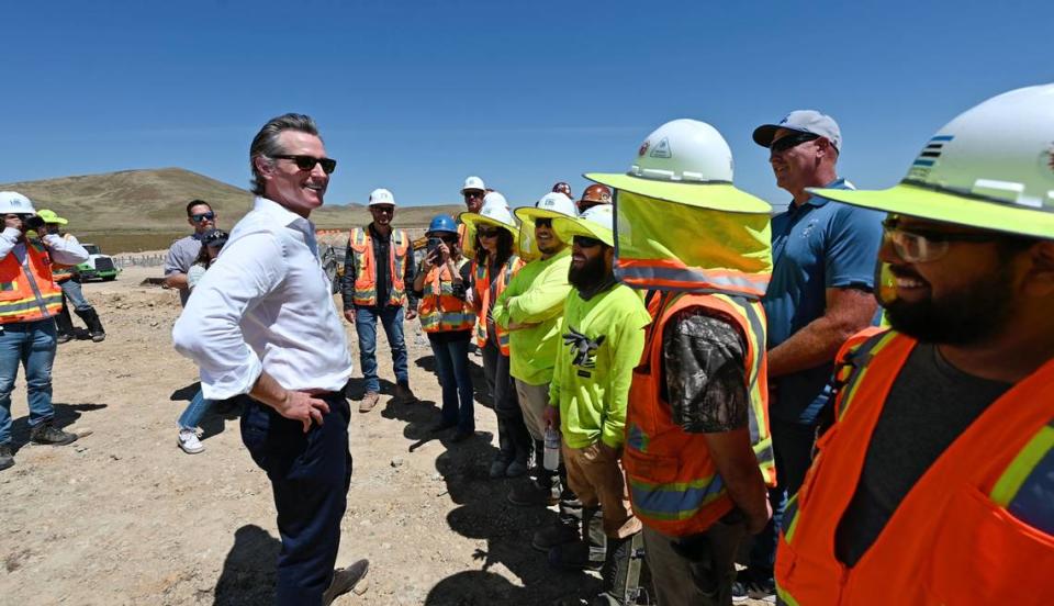 California Gov. Gavin Newsom talks with union electricians after an infrastructure announcement at Proxima Solar Farm outside Patterson, Calif., Friday, May 19, 2023. Newsom on Friday signed an executive order laying the groundwork for a bold plan to expedite major transportation, water, clean energy and other infrastructure projects across California.