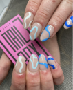 <p>Even if you're not spending this Fourth of July poolside, you can bring the pool to you with these fun, wave-inspired nails in different shades of blue. </p>