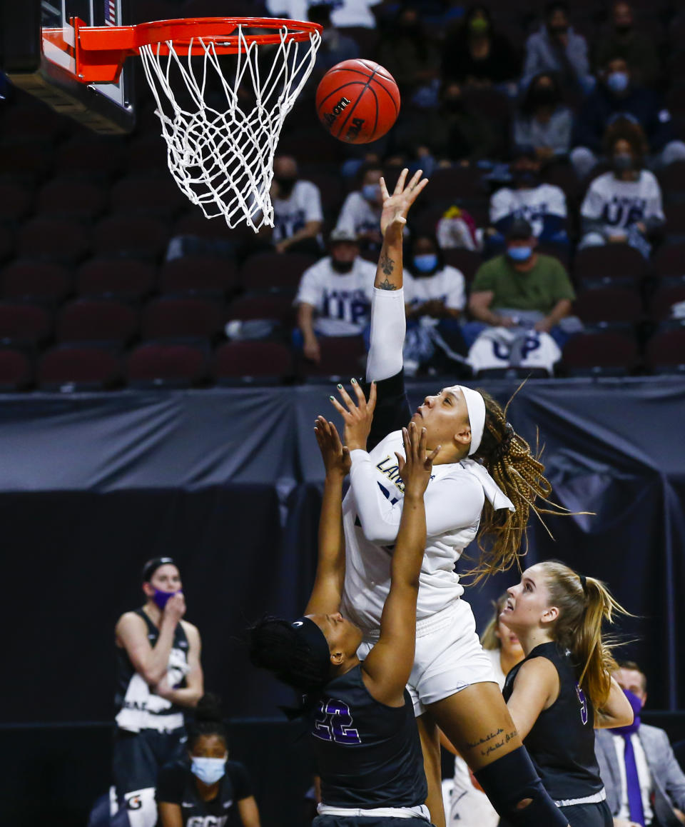 California Baptist's Britney Thomas, top, attempts a layup against Grand Canyon's Ny'Dajah Jackson (22) during the first half of an NCAA college basketball game for the championship of the Western Athletic Conference women's tournament Saturday, March 13, 2021, in Las Vegas. (AP Photo/Chase Stevens)