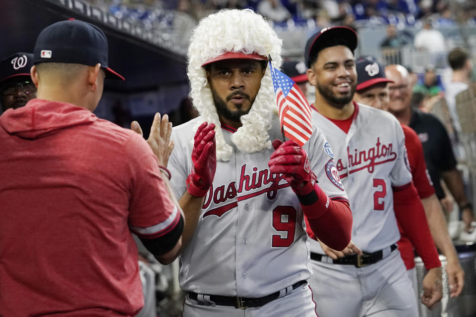 Washington Nationals Jeimer Candelario (9) is congratulated by his teammates after hitting a home run in the fourth inning during a baseball game against the Miami Marlins, Thursday, May 18, 2023, in Miami. (AP Photo/Marta Lavandier)