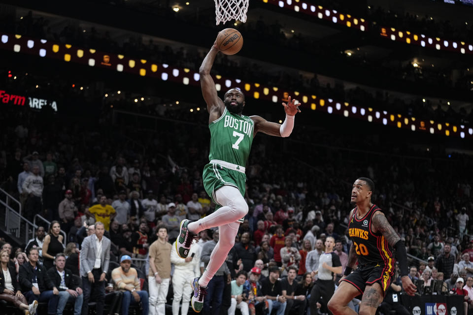 Boston Celtics guard Jaylen Brown (7) shoots and scores against the Atlanta Hawks during the first half of Game 4 of a first-round NBA basketball playoff series, Sunday, April 23, 2023, in Atlanta. (AP Photo/Brynn Anderson)