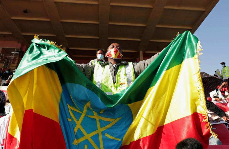 A volunteer holds an Ethiopian flag during a blood donation ceremony for the injured members of Ethiopia's National Defense Forces fighting against Tigray's special forces on the border between Amhara and Tigray, at the stadium in Addis Ababa, Ethiopia, November 12, 2020. / Credit: Reuters/Tiksa Negeri