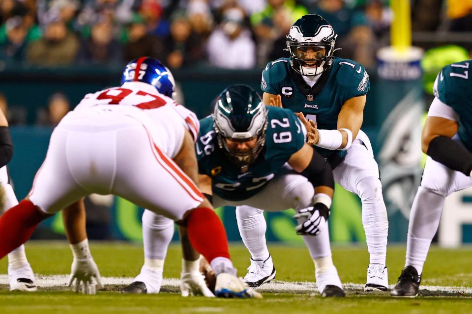 Philadelphia Eagles quarterback Jalen Hurts (1) gets the snap from center Jason Kelce (62) against New York Giants defensive tackle Dexter Lawrence (97) during an NFL divisional round playoff football game, Saturday, Jan. 21, 2023, in Philadelphia. (AP Photo/Rich Schultz)