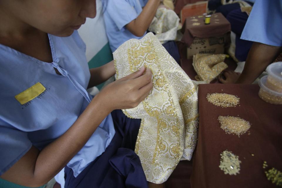 In this Jan. 6, 2017 photo, transgender inmates learn embroidery at Pattaya Remand Prison in Pattaya, Chonburi province, Thailand. The prison separates lesbian, gay, bisexual and transgender prisoners from other inmates, a little-known policy despite being in place nationwide since 1993, according to the Department of Corrections. (AP Photo/Sakchai Lalit)