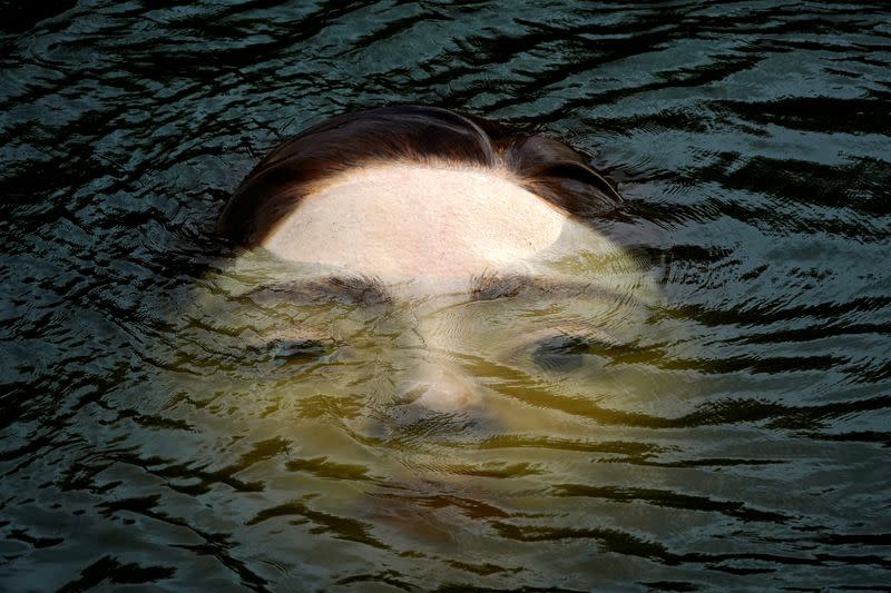 A fibreglass sculpture entitled 'Bihar' is submerged in the Nervion river in Bilbao