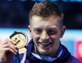 Swimming – 17th FINA World Aquatics Championships – Men's 100m Breaststroke awarding ceremony – Budapest, Hungary – July 24, 2017 – Adam Peaty of Britain (gold) poses with the medal. REUTERS/Bernadett Szabo