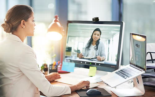 A woman using Zoom to video conference with another woman.