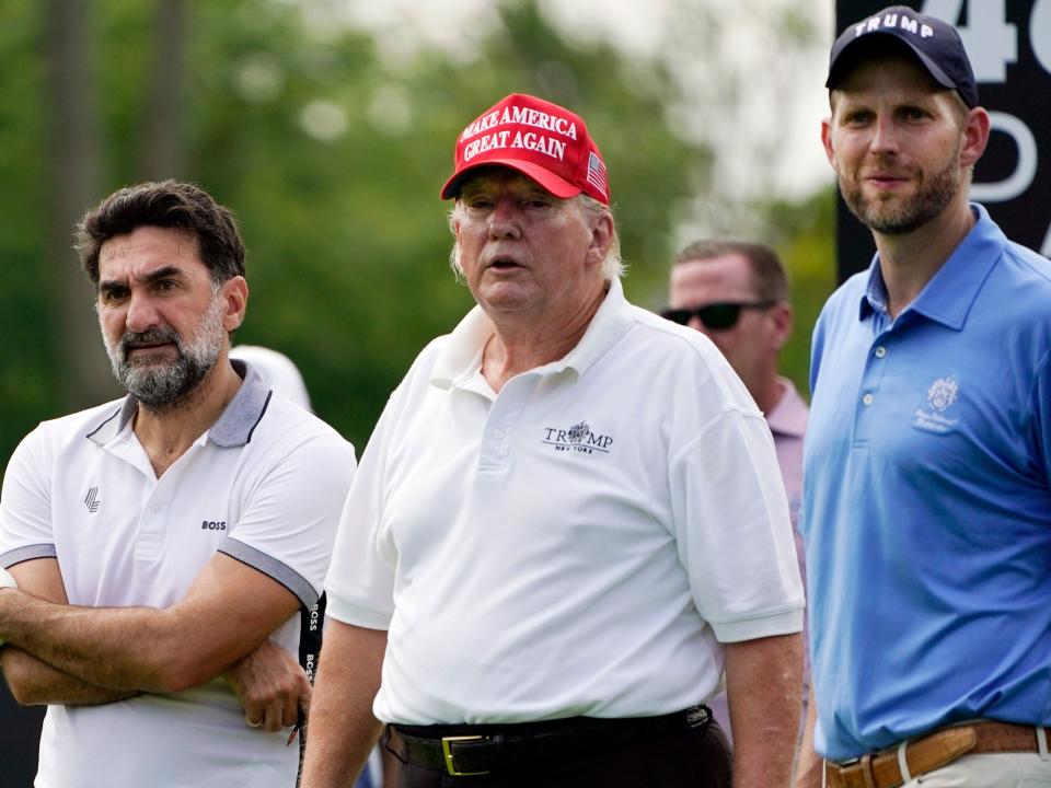 Former President Trump stands with his son Eric and Yasir Al-Rumayyan, left, a governor of Saudi Arabia's Public Investment Fund.