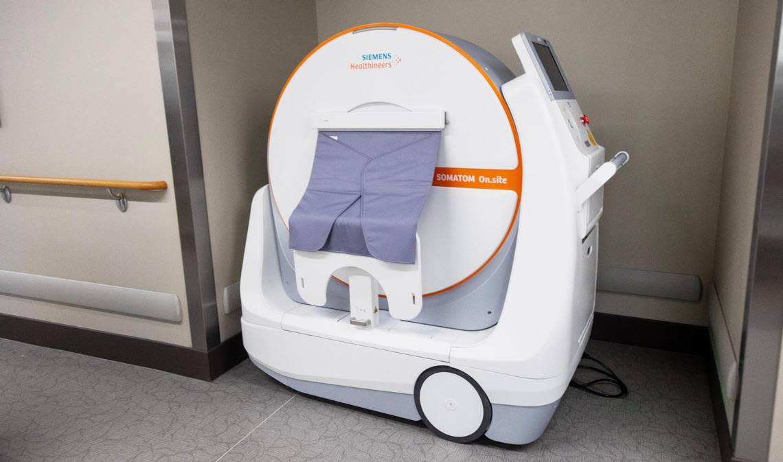 A mobile CT scanner in the hallway.