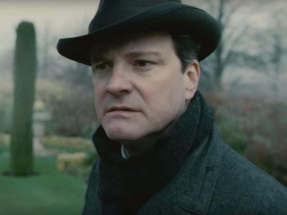 Colin Firth as King George VI wearing a hat and scarf