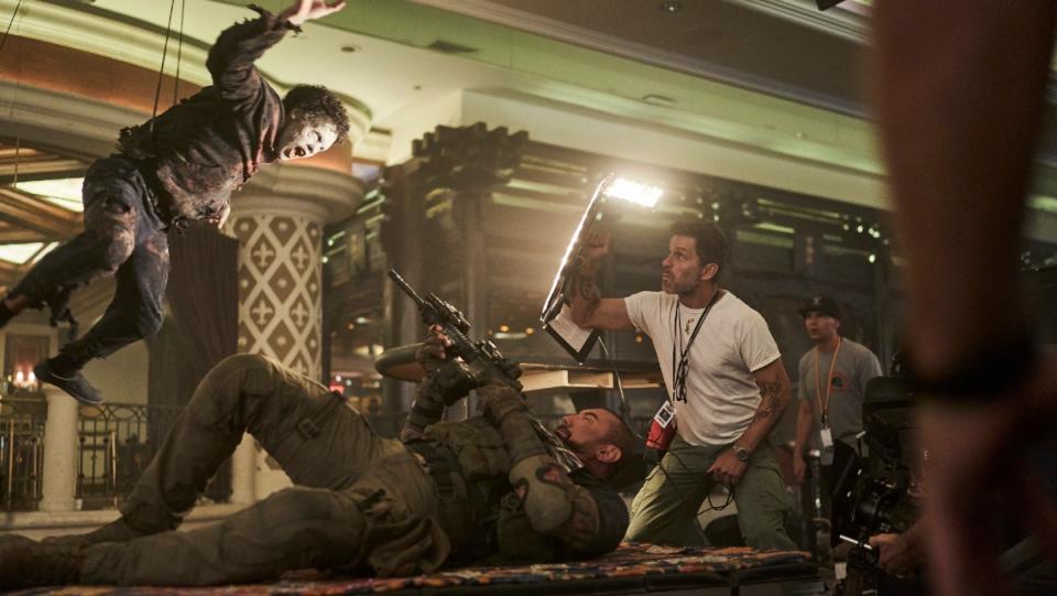 Zack Snyder films a zombie on wires in a behind-the-scenes shot from Army of the Dead.