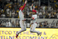Philadelphia Phillies shortstop Bryson Stott celebrates with second baseman Jean Segura after their win against the San Diego Padres after Game 1 of the baseball NL Championship Series between the San Diego Padres and the Philadelphia Phillies on Tuesday, Oct. 18, 2022, in San Diego. (AP Photo/Gregory Bull)