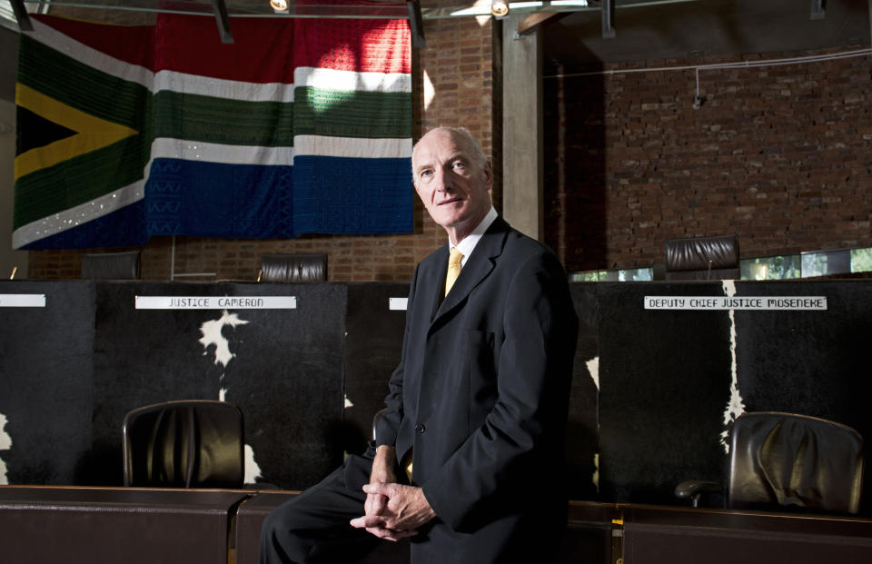 In this photo taken Wednesday, Feb. 5, 2014, Constitutional Court Judge Edwin Cameron is photographed inside the Constitutional Court In Johannesburg. In his published book “Justice: A Personal Account,” Cameron traces the hardship of his early life. Through a top education, he discovered the law as a way to repair a racially torn society and his own life, as well as the 1986 discovery that he was HIV positive. (AP Photo/Madelene Cronjé) South Africa Out