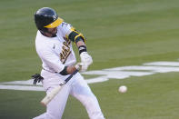 Oakland Athletics' Jed Lowrie hits a two-run double against the Toronto Blue Jays during the second inning of a baseball game in Oakland, Calif., Tuesday, May 4, 2021. (AP Photo/Jeff Chiu)