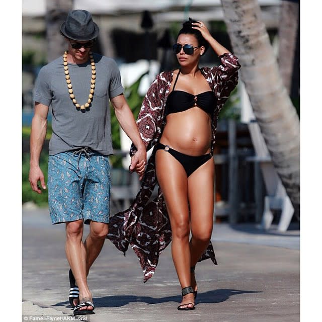 <strong>Naya Rivera</strong> is looking hotter than ever while flaunting her baby bump! Less than two months after announcing her pregnancy, the former <em>Glee </em>star and her husband <strong> Ryan Dorsey</strong> are enjoying a vacation in "paradise" before their little bundle arrives in the world. On Saturday, the 28-year-old actress shared an Instagram pic of her wading in the water wearing an itty-bitty tan bikini with the simple caption: "baby moon." <strong> WATCH: Glee's Heather Morris is 'Excited' Naya Rivera is Pregnant! </strong> If Rivera's Instagram photos are any indication, the happy couple is definitely having a wonderful time together on their Hawaiian vacay. Rivera and Dorsey were spotted walking hand-in-hand while the brunette beauty showed off her tan and pregnant belly in a black bikini and a printed cover-up. After taking in the gorgeous sunset views, Rivera and her hubby spent their Sunday morning "with some couples meditation on the beach then a walk around paradise." Consider us jealous!