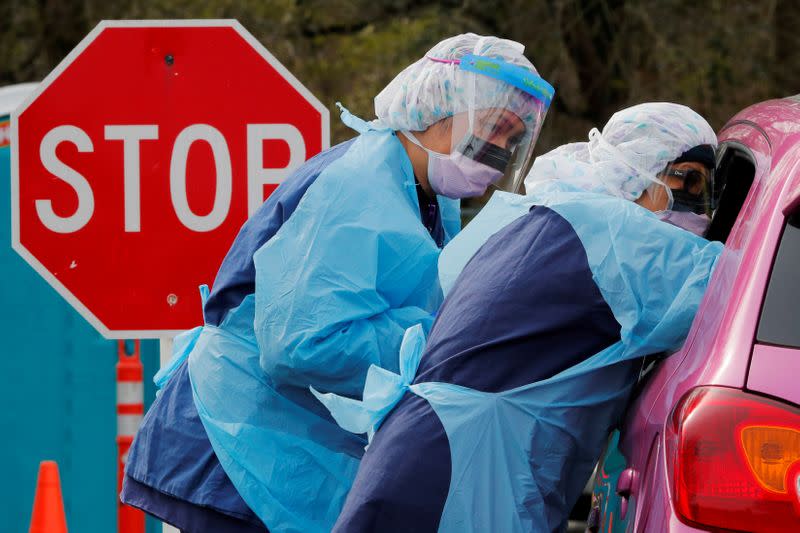 FILE PHOTO: Coronavirus tests are administered at a drive-through site in Seattle