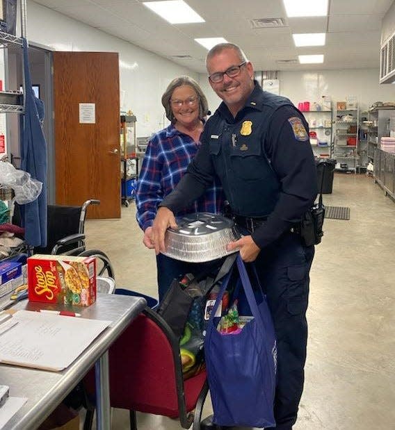 Cheboygan Police Officer Ron White worked with representatives of The Lord's Kitchen to deliver turkeys to people in need on Monday morning.