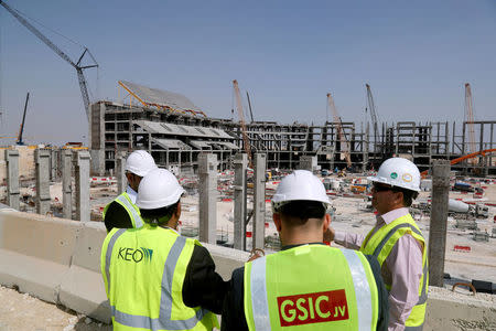 FILE PHOTO: Visitors and engineers stand at the construction site of Al-Bayt stadium in Al-Khor, north of Doha, Qatar February 22, 2017. REUTERS/Stringer/File Photo