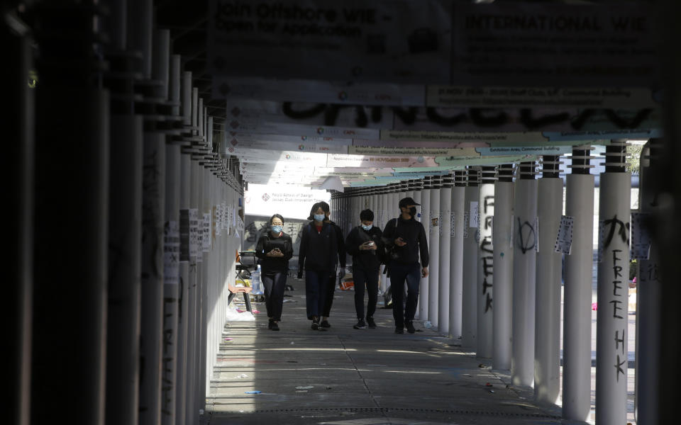 Protesters walk at the campus of Hong Kong Polytechnic University in Hong Kong Friday, Nov. 22, 2019. Most of the protesters who took over the university last week have left, but an unknown number have remained inside for days, hoping somehow to avoid arrest. (AP Photo/Achmad Ibrahim)