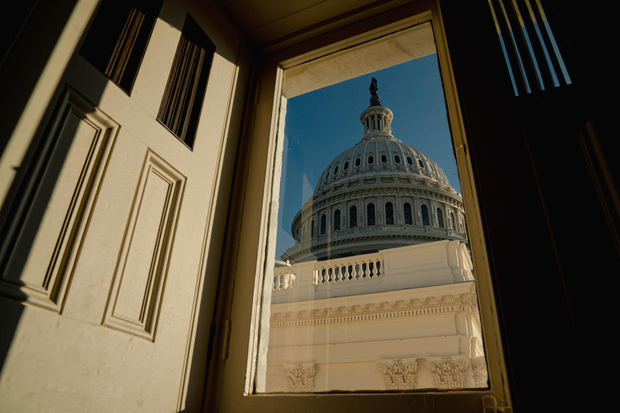 The Capitol building is seen through a glass door panel in Washington on Nov. 13, 2023. (Shuran Huang/The New York Times)