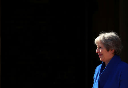 Britain's Prime Minister Theresa May waits to greet heads of state as they arrive for a working session at the Commonwealth Heads of Government Meeting in London, April 19, 2018. REUTERS/Hannah McKay