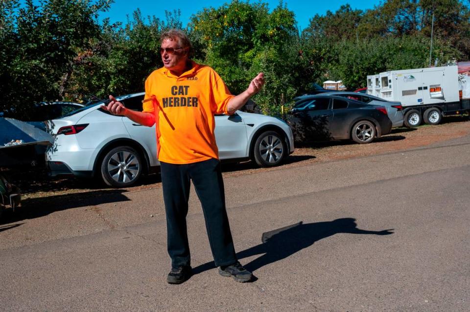 Jerry Visman, the owner of High Hill Ranch, wears a shirt that says “cat herder” while directing traffic as people visit the ranch Saturday at Apple Hill.