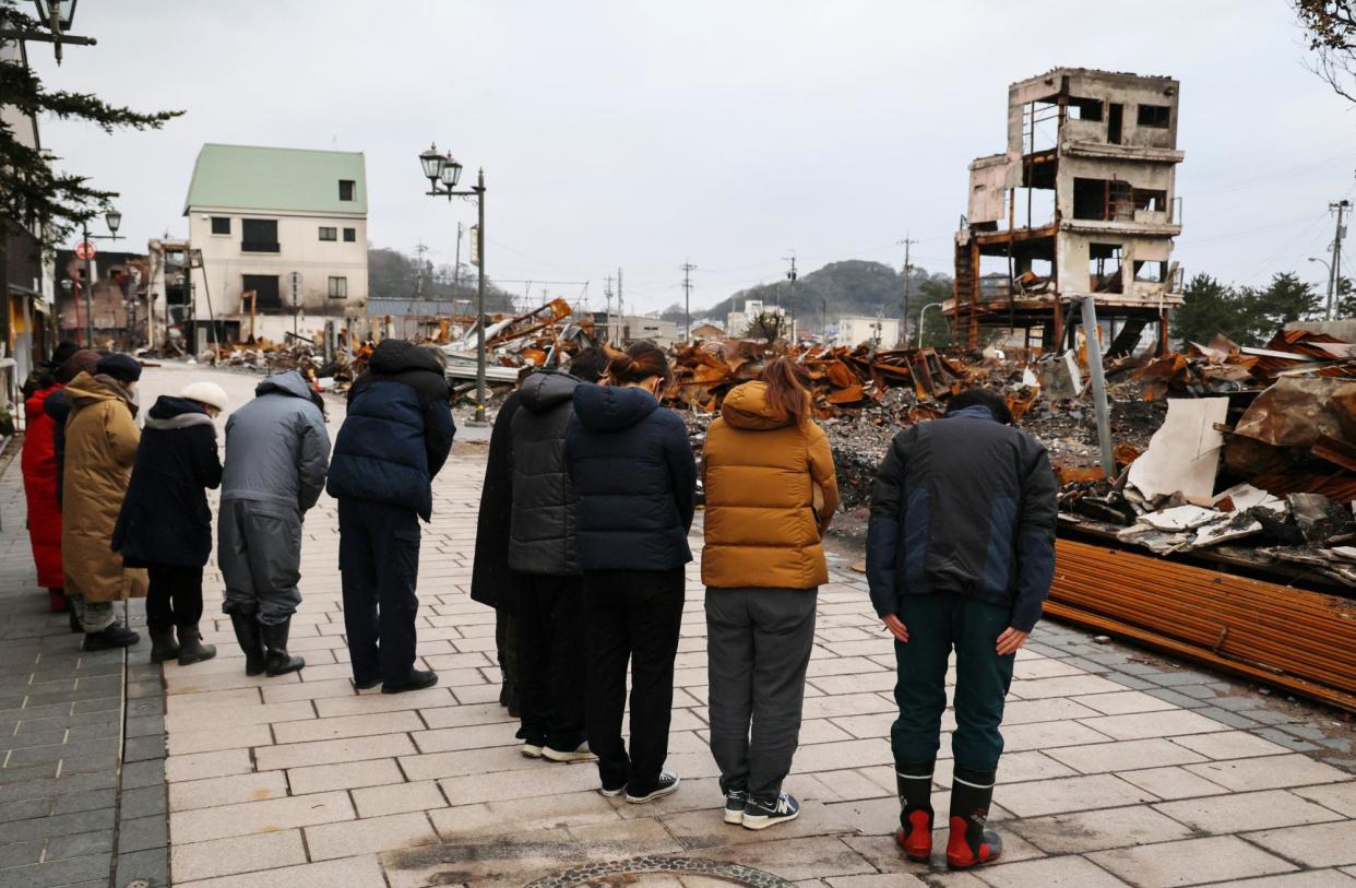 <span>Residents in Wajima offer their prayers, a month after an earthquake killed more than 200 on Japan’s Noto peninsula. </span><span>Photograph: Jiji Press/EPA</span>