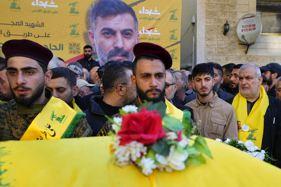 Mohammed Raad, right, the head of Hezbollah's parliamentary bloc, stands next to the coffin of his son Abbas Mohammed Raad, who was killed by an Israeli strike, during his funeral procession in the southern town of Jbaa, Lebanon, Thursday, Nov. 23, 2023. The militant Hezbollah group fired more than 50 rockets at military posts in northern Israel on Thursday, a day after an Israeli airstrike on a home in southern Lebanon killed five of the group's senior fighters. (AP Photo/Bilal Hussein)