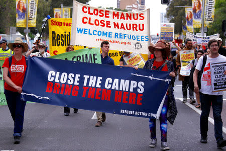 Refugee advocates hold placards as they participate in a protest in central Sydney, against the treatment of asylum-seekers in detention centres located in Nauru and on Manus Island, Australia, October 15, 2017. REUTERS/David Gray