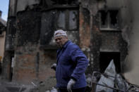 Anatolii Chovpin stands outside the damagde building where he lives ruined by attacks in Irpin, on the outskirts of Kyiv, Ukraine, Thursday, May 26, 2022. (AP Photo/Natacha Pisarenko)