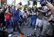 Former Greek Finance Minister Yanis Varoufakis is surrounded by the media as he leaves the Finance Ministry in Athens, Greece July 6, 2015. REUTERS/Jean-Paul Pelissier