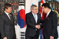 International Olympic Committee (IOC) president Thomas Bach from Germany, shakes hands with North Korea's Olympic Committee President and Minister of Physical Culture and Sports Kim Il Guk, as South Korean Sports Minister Do Jong-hwan looks on, prior a meeting with the IOC for their bid to co-host the 2032 Summer Olympics, at the IOC Headquarters in Lausanne, Switzerland, February 15, 2019. Salvatore Di Nolfi/Pool via REUTERS