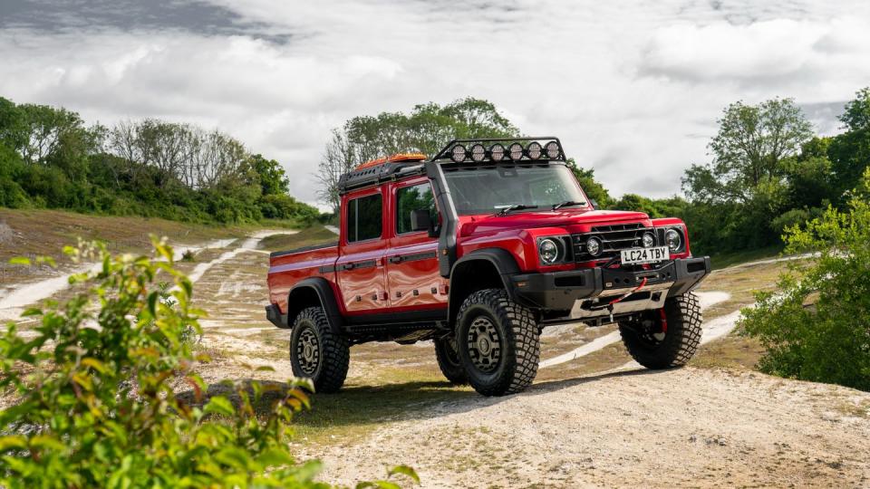 a red truck on a dirt road