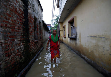 A woman walks along a flooded alley in Janakpur, Nepal August 13, 2017. REUTERS/Navesh Chitrakar