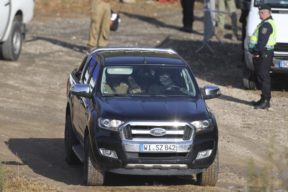 A German registered vehicle drives away as police search teams set out from an operation tent near Barragem do Arade, Portugal, Wednesday May 24, 2023. Portuguese police aided by German and British officers have resumed their search for Madeleine McCann, the British child who disappeared in the country's southern Algarve region 16 years ago. Some 30 officers could be seen in the area by the Arade dam, about 50 kilometers (30 miles) from Praia da Luz, where the 3-year-old was last seen alive in 2007. (AP Photo/Joao Matos)