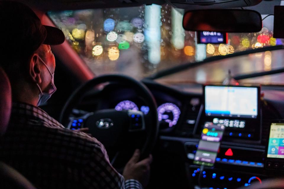 A taxi driver navigates the rainy weather during a fare in Seoul.