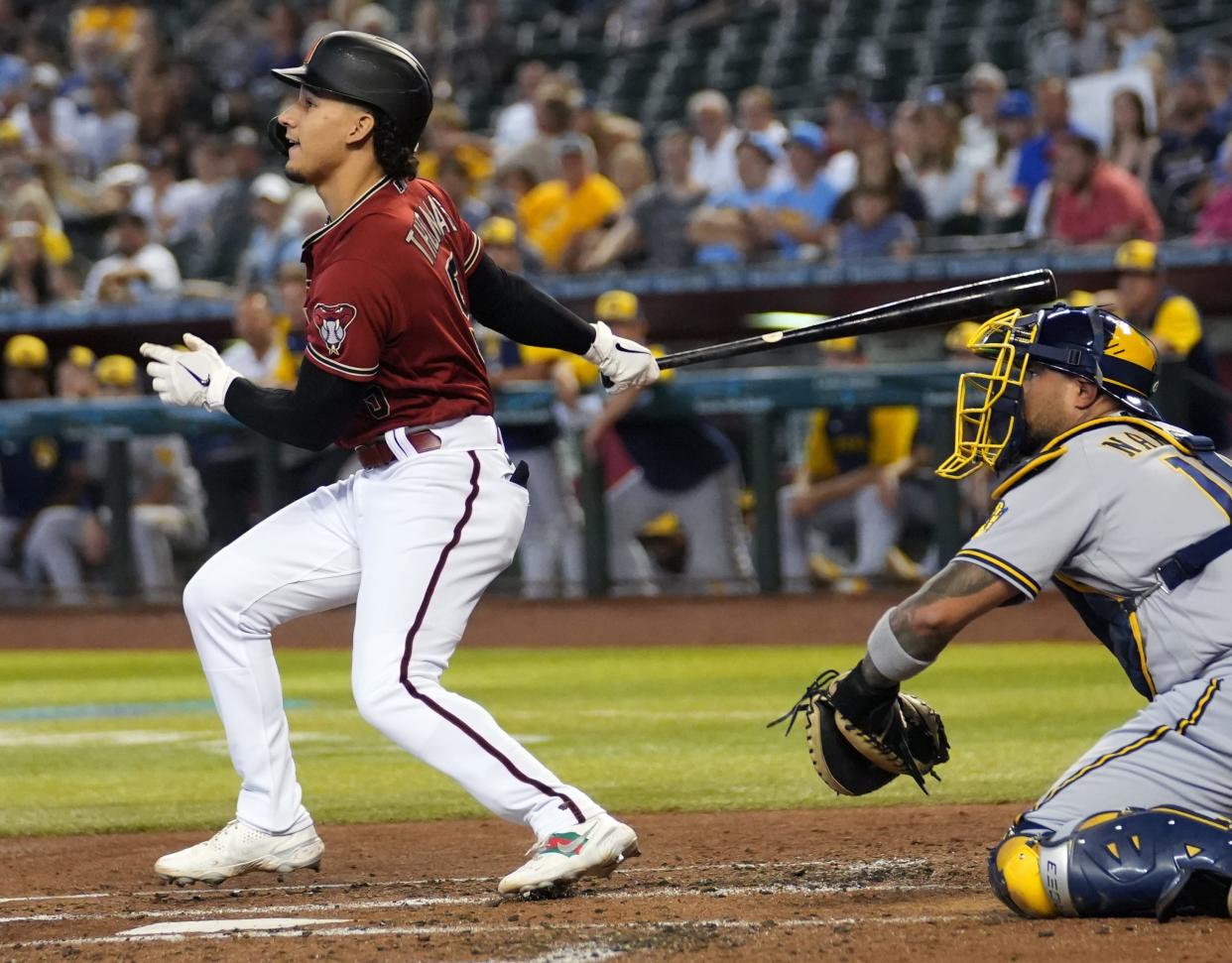 Sep 4, 2022; Phoenix, AZ, USA; Arizona Diamondbacks' Alek Thomas hits a sacrifice fly against the Milwaukee Brewers at Chase Field.