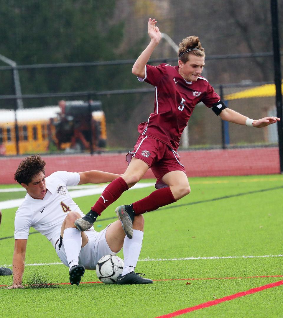From left, Arlington's Martin Mlynarski (4) and Kingston's Max Maouris (5) battle for ball control during the boys Class AAA soccer regional final at FDR-Hyde Park Nov. 4, 2023.