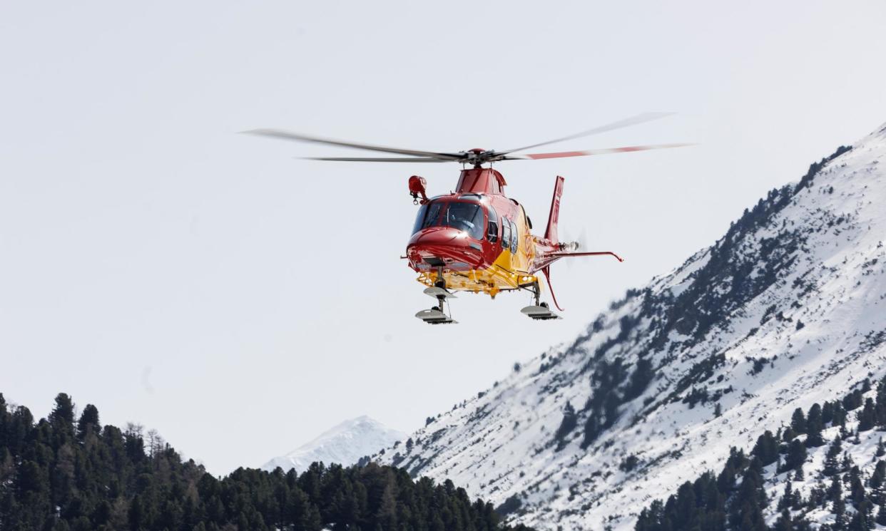 <span>A helicopter flies overhead during rescue efforts after the avalanche in Austria.</span><span>Photograph: Jan Hetfleisch/Getty Images</span>