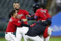 Cleveland Guardians' Amed Rosario (1) celebrates with teammates after hitting a game-winning single off Tampa Bay Rays relief pitcher Javy Guerra during the 10th inning of a baseball game, Wednesday, Sept. 28, 2022, in Cleveland. The Guardians defeated the Rays 2-1. (AP Photo/Ron Schwane)