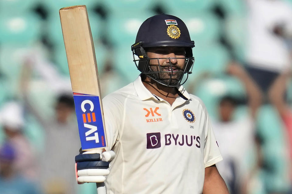 India's captain Rohit Sharma raises his bat to celebrate scoring fifty runs during the first day of the first cricket test match between India and Australia in Nagpur, India, Thursday, Feb. 9, 2023. (AP Photo/Rafiq Maqbool)