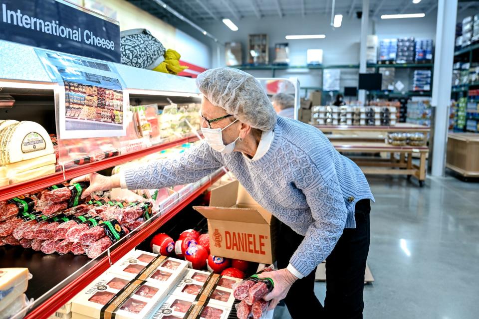 Kathy Scholl stocks meats and cheeses ahead of the grand opening at BJ's Wholesale Club on Wednesday, Jan. 26, 2022, in Delta Township.