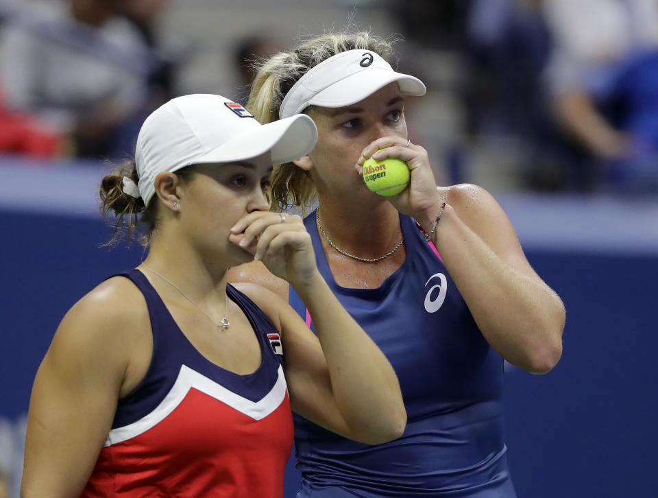 Ashleigh Barty, of Australia, left, talks with doubles partner CoCo Vandeweghe during the women's double final of the U.S. Open tennis tournament against Timea Babos, of Hungary, and Kristina Mladenovic, of France, Sunday, Sept. 9, 2018, in New York. (AP Photo/Darron Cummings)