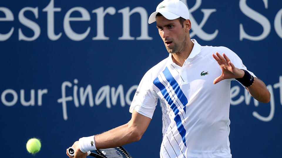 Novak Djokovic returns a shot to Tennys Sandgren during the Western & Southern Open. (Photo by Matthew Stockman/Getty Images)