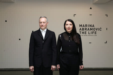 Artist Marina Abramovic and actor Todd Eckert pose for a photograph ahead of 'The Life' exhibition, the world's first large-scale performance exhibited using Mixed Reality at the Serpentine Gallery in London, Britain February 18, 2019. REUTERS/Simon Dawson