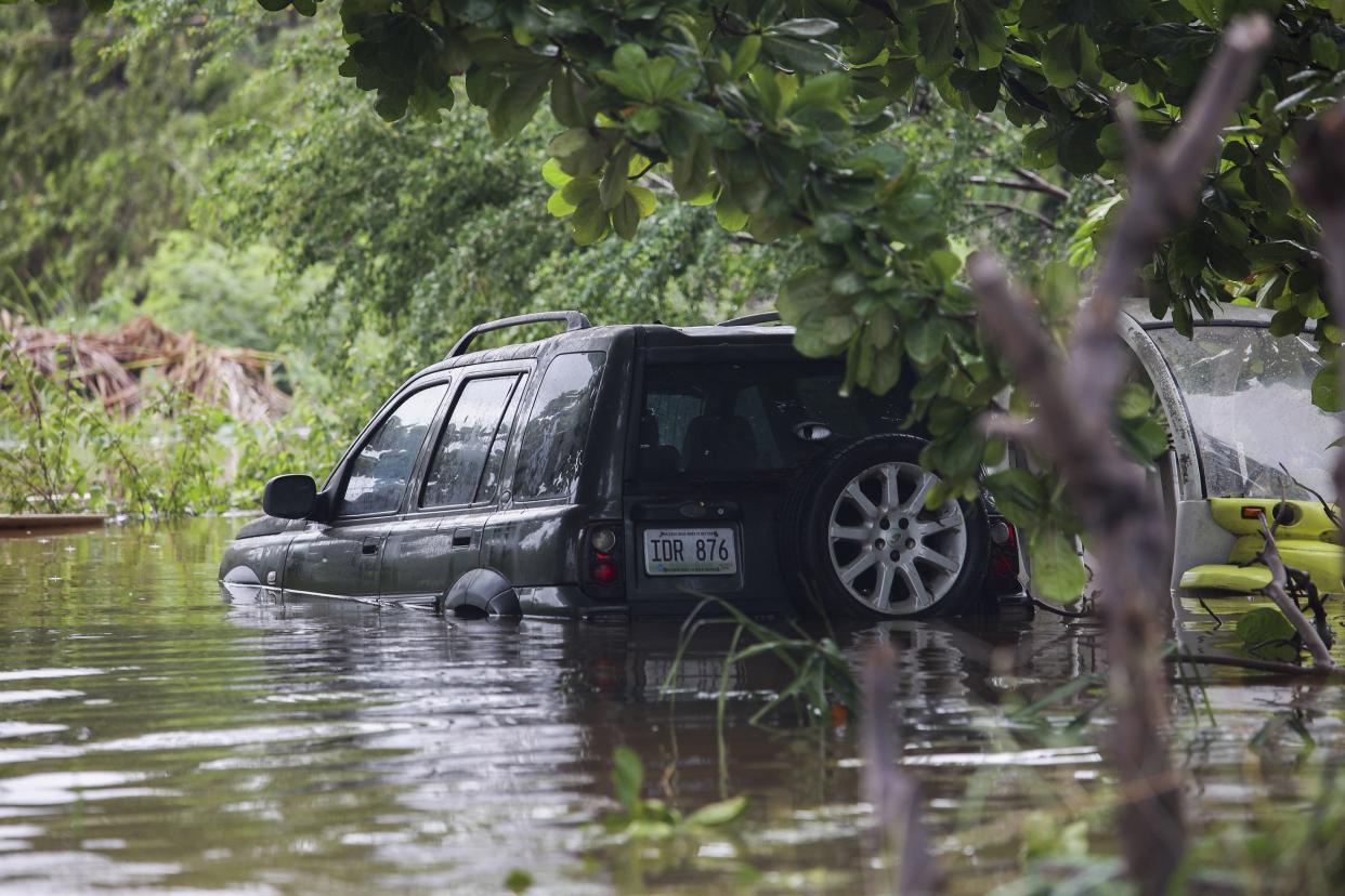 A vehicle is submerged after Hurricane Fiona in Salinas, Puerto Rico, Monday, Sept. 19, 2022.